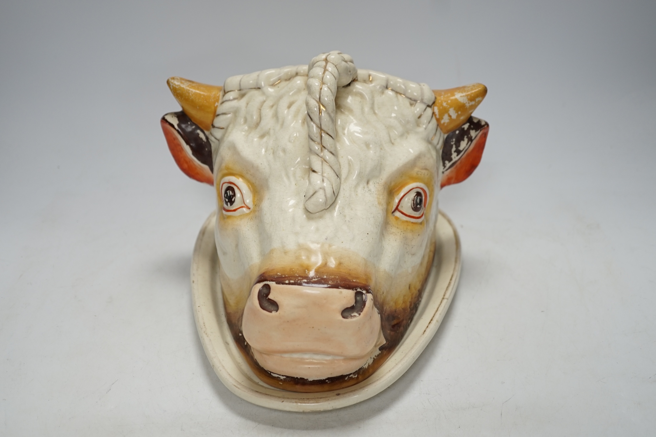 A Victorian ‘cows head’ pottery cheese dish and cover, 18cm